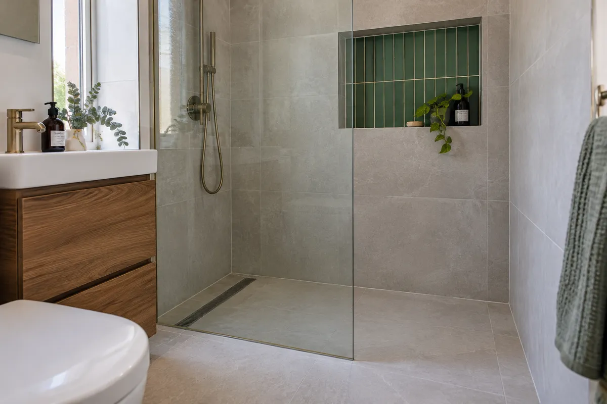 Tiled shower floor with a linear drain and recessed wall shelf